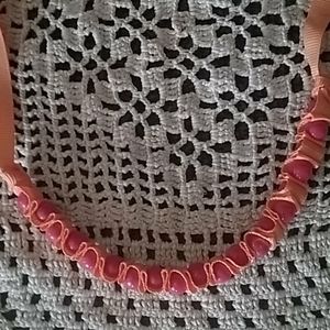 Handmade necklace with ribbon and beads.